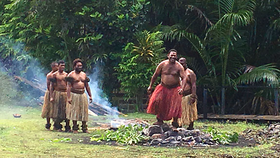 A Fijian firewalker walking on hot stones